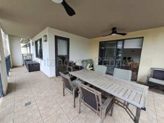 Open plan living and dining area with sliding doors to terrace in PH River Valley Panama Pacifico condo for sale