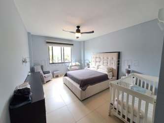 Spacious master bedroom with king bed, nursery crib, fan in PH River Valley Panama Pacifico