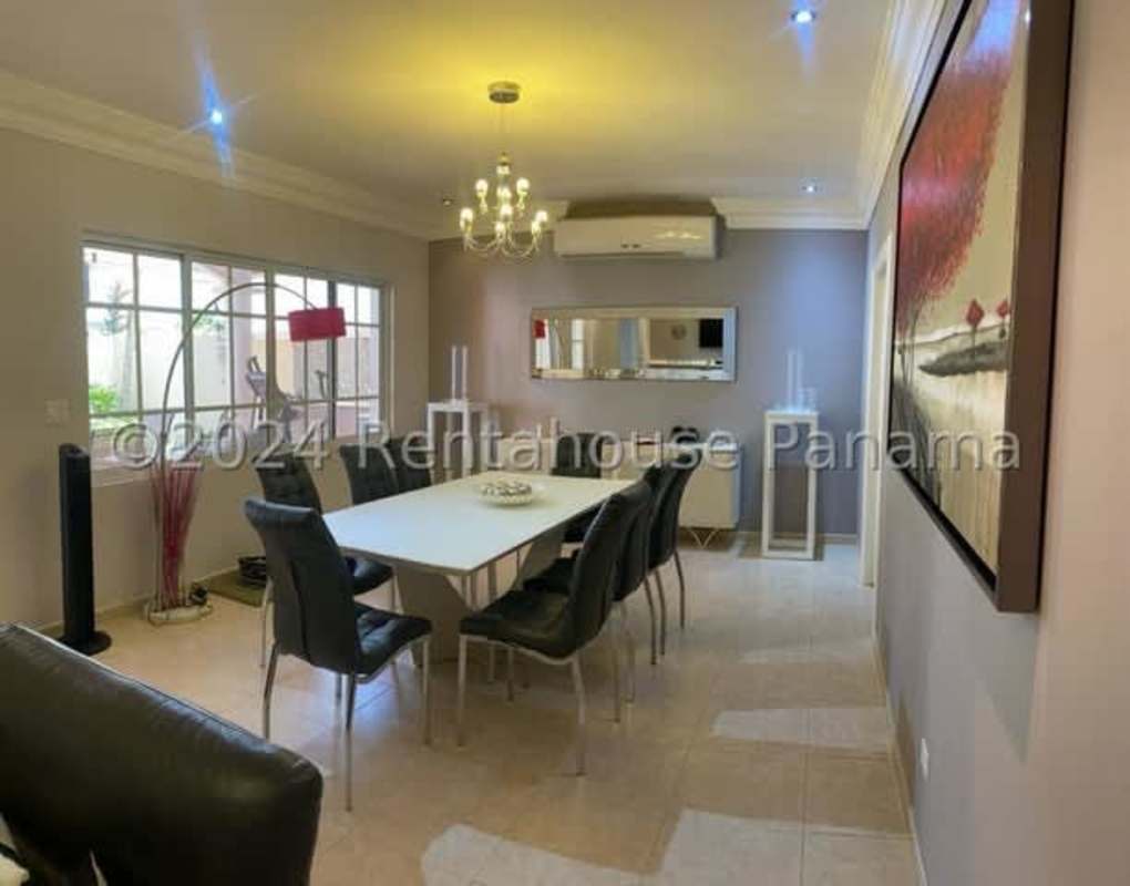 Spacious dining room with large window, chandelier, air conditioning in Costa del Este luxury house Panama