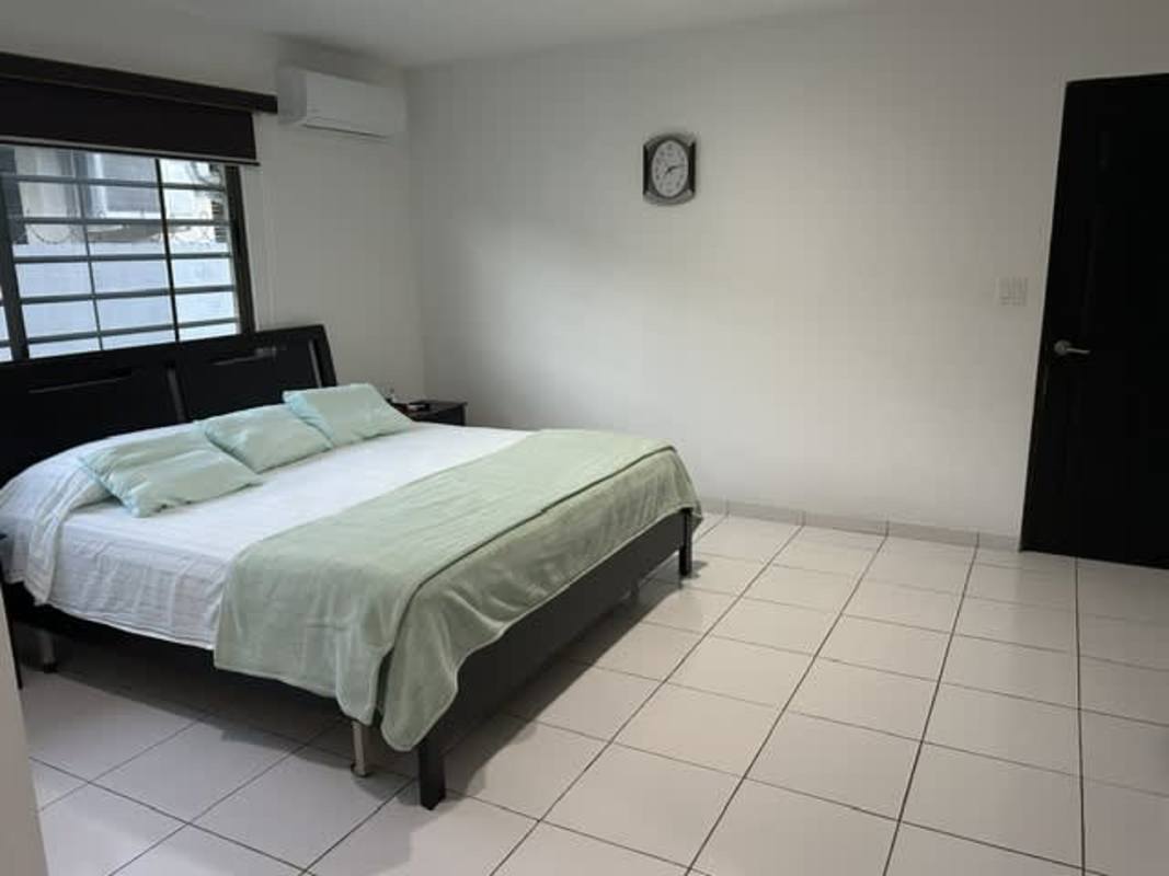 Large tiled terrace with garden view suburban house Chanis for sale Panama City