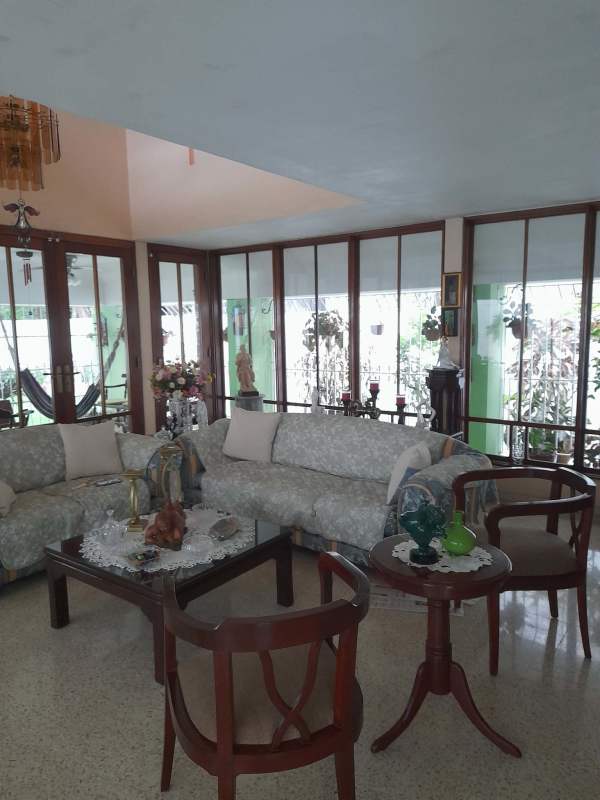 Large vintage kitchen with wooden cabinets, round dining table, gas stove in La Alameda El Dorado Panama
