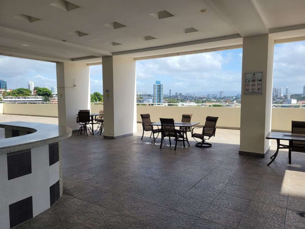 Covered rooftop terrace with seating overlooking Panama City skyline Edison Park