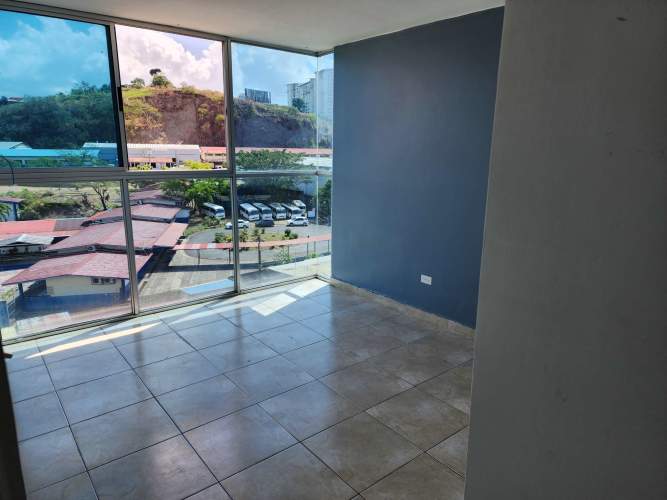 Living area with corner glass windows and balcony in Villa Lucre Panama City