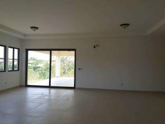 Open living area with large glass doors and garden views beach house San Carlos