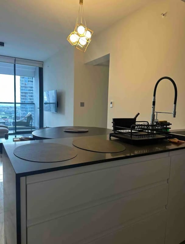 Luxurious master bedroom with panoramic ocean view floor to ceiling windows at PH Nuovo Armani Panama