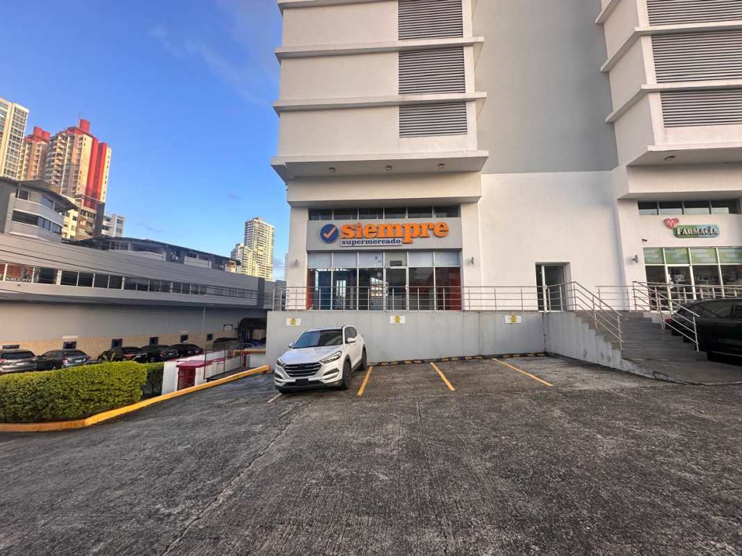 Retail commercial plaza with parking supermarket pharmacy signage along Via España Panama City