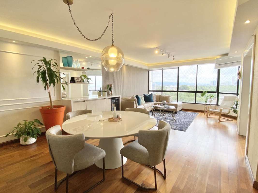 Bright living and dining area with floor-to-ceiling windows and Pacific views PH Luna del Mar