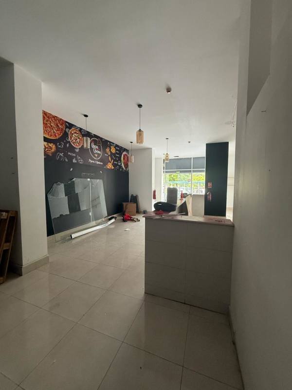 Vacant tiled commercial space with glass frontage pendant lighting in Panama City Rio Abajo