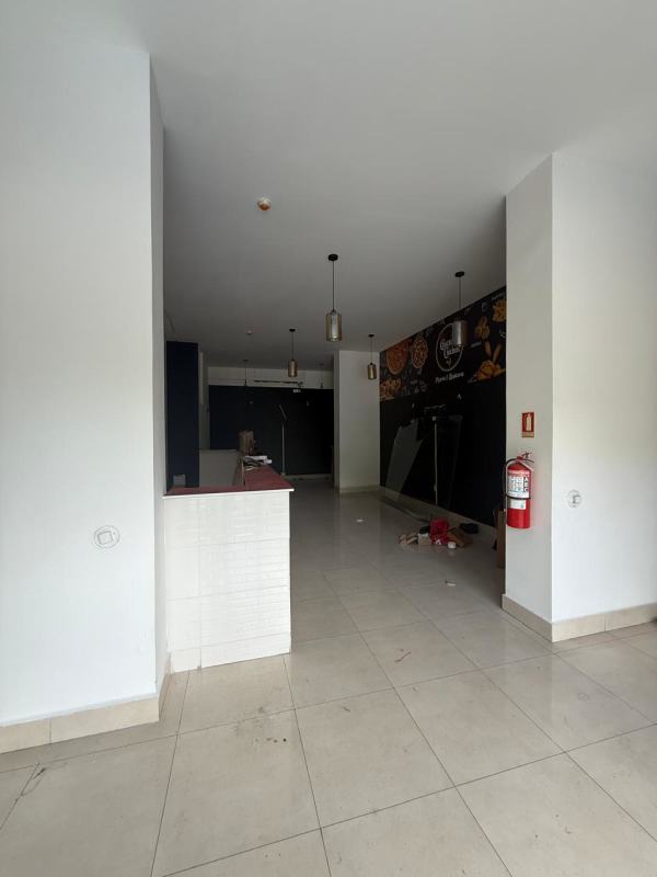 Glass-fronted vacant retail space with counter and pendant lights in Río Abajo Panama