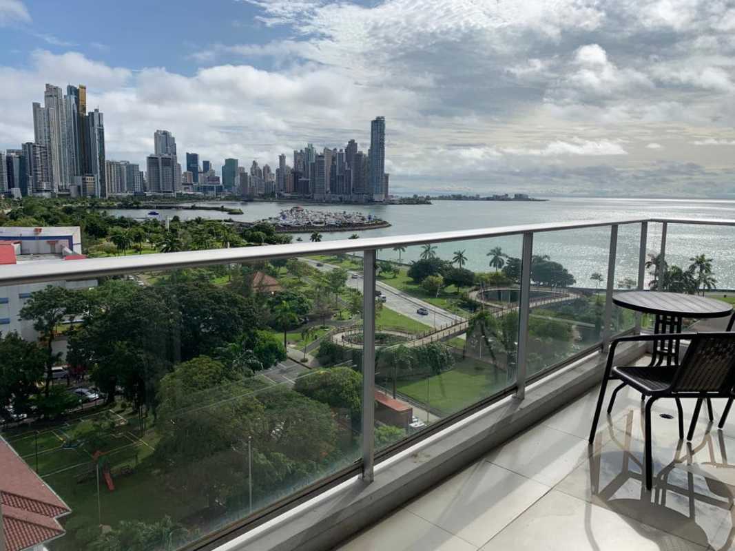 Furnished dining space with large windows and sea view in PH BICSA apartment Panama City