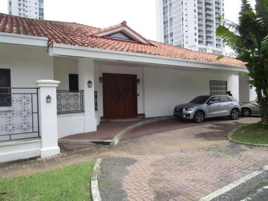 Spacious elegant living and dining area with chandelier and coffered ceiling in luxury residence Altos del Golf Panama City