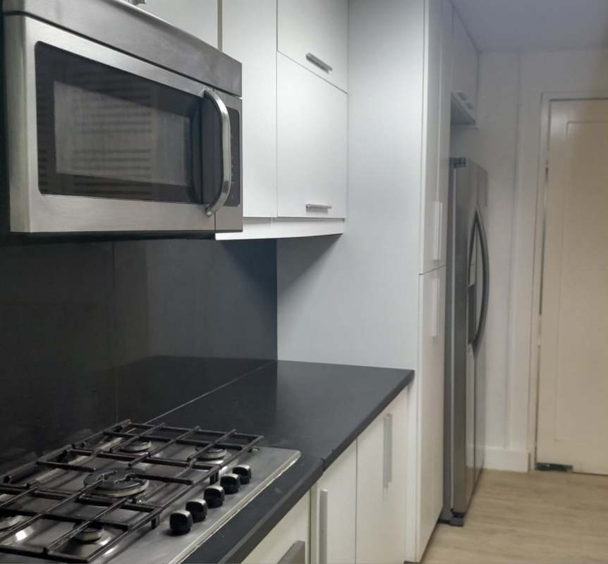 Kitchen with white cabinets, black countertops, stainless appliances in San Francisco house for rent