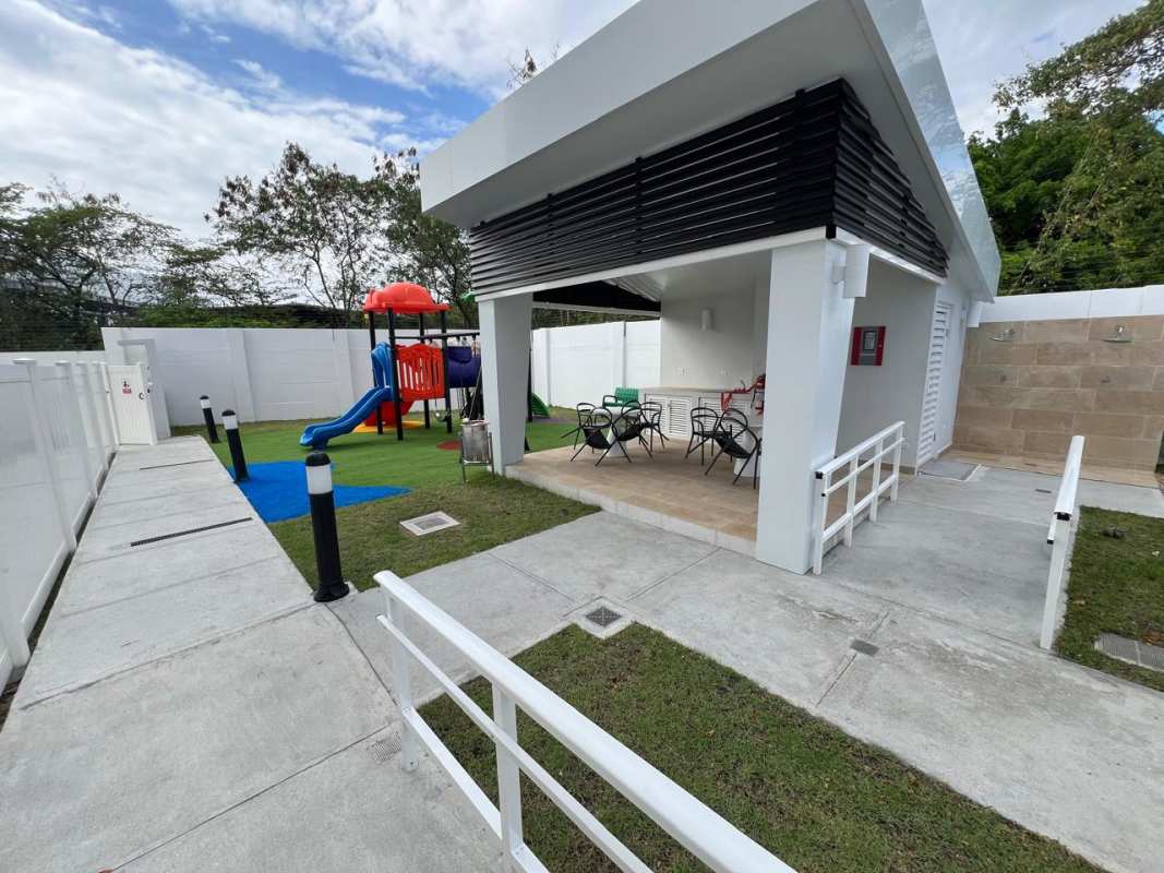 Kid's play area with slides swings pavilion and garden at Panama Viejo Residences Chanis Panama City