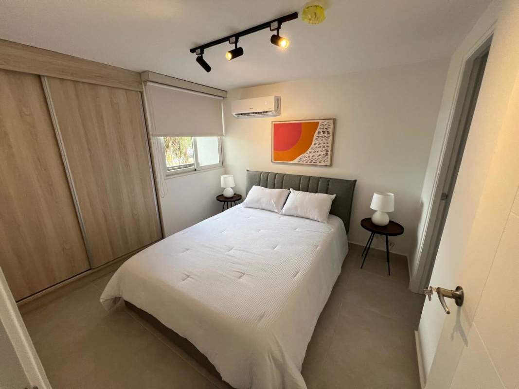 Main bedroom with wardrobe space and AC ready outlet at Panama Viejo Residences apartment for rent in Chanis area