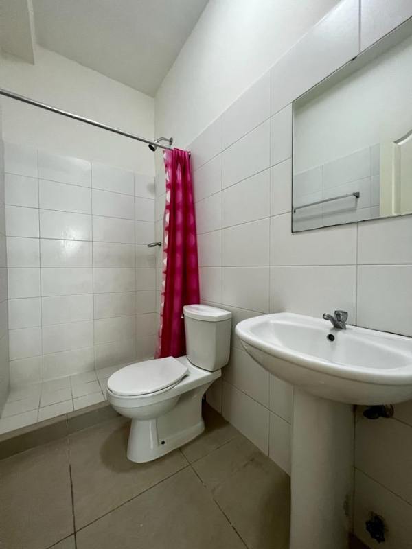 Minimalist second bathroom with white tiles and walk-in shower PH Club de Golf Panama City