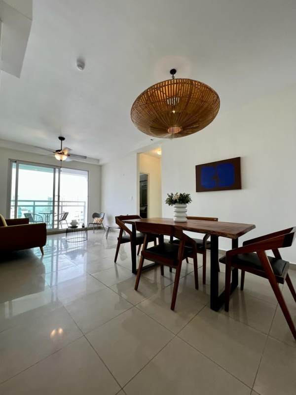 Furnished living space with mustard sofa, dining area, and balcony PH Club de Golf San Francisco Panama City