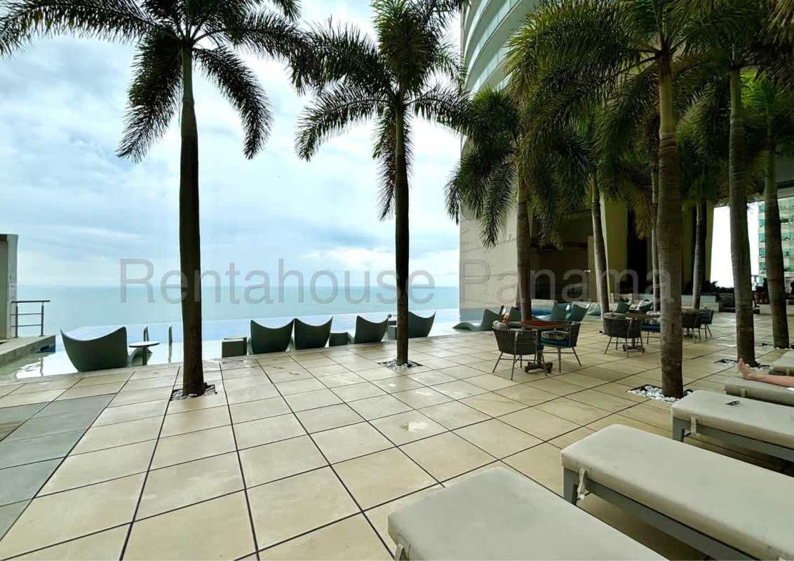 Expansive terrace with infinity pool, palm trees, and Pacific Ocean backdrop in Panama