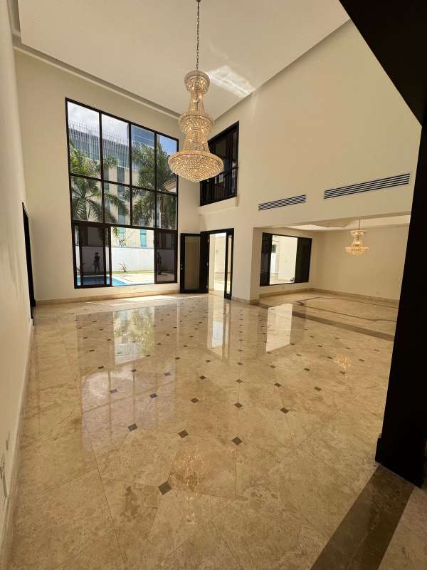 Double height marble floor living area with large windows Costa del Este house Panama City