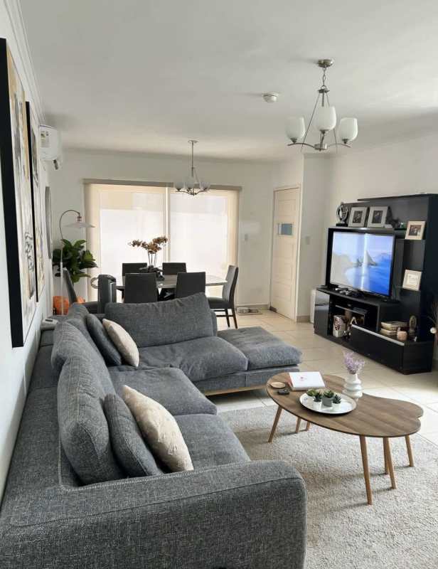 Modern living dining room with sectional sofa, TV, dining table in PH Augusta Brisas del Golf Panama