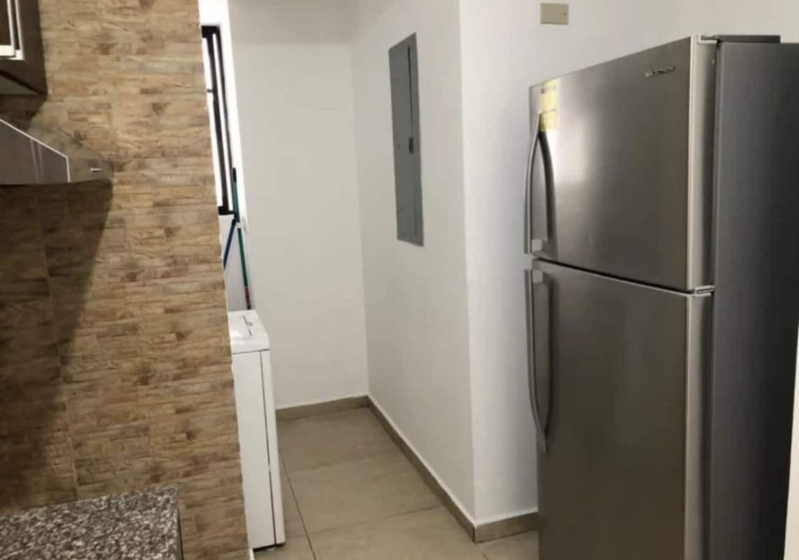 Laundry space with washer, utility cabinet and granite countertop, PH Terrazas del Rey Panama City