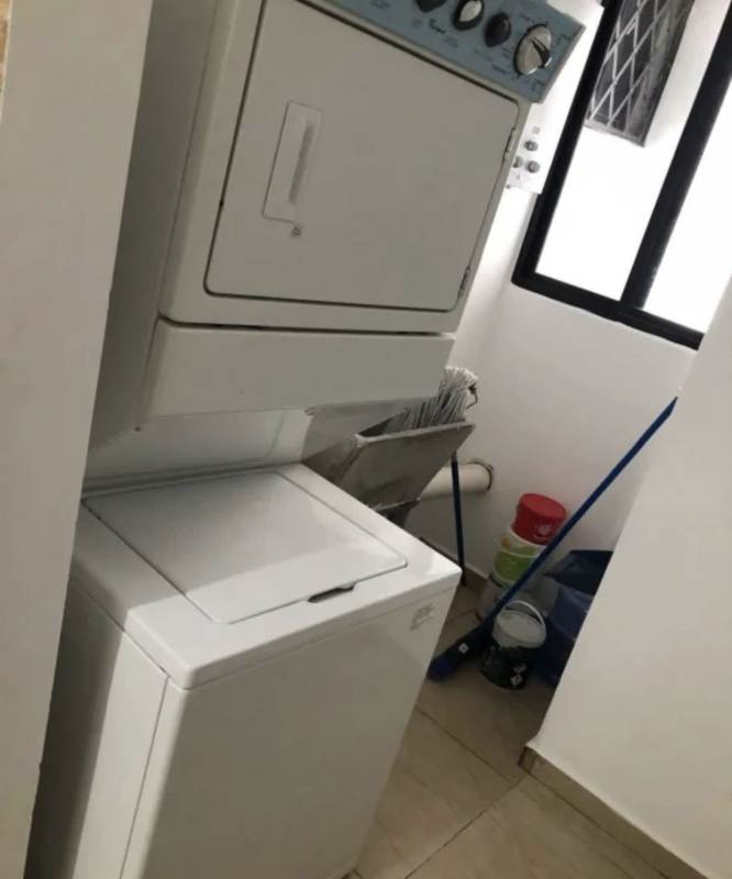 Compact laundry room with stacked washer and dryer, and storage, PH Terrazas del Rey Panama City
