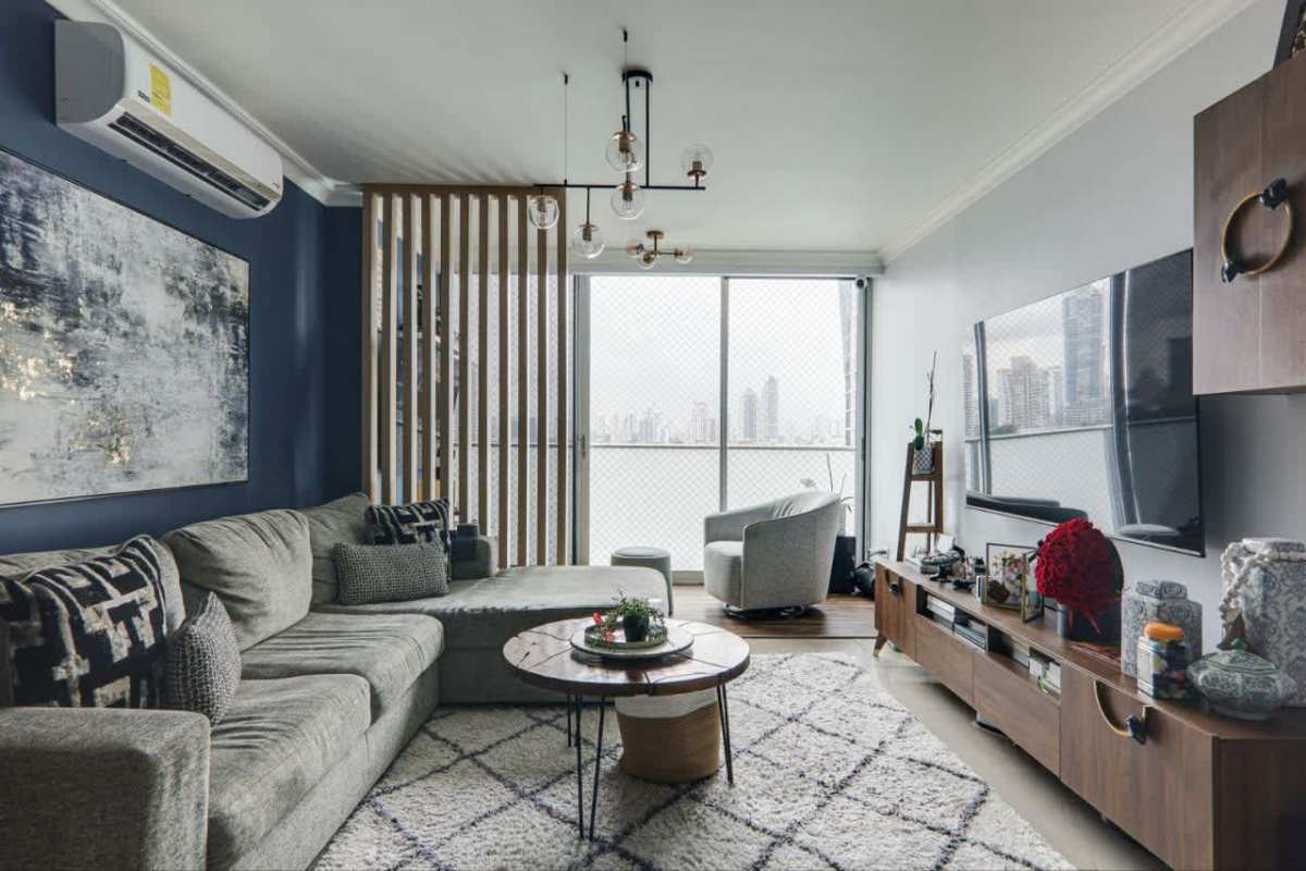 Chic dining room with blue accent wall adjacent to open kitchen Pacific Sun Punta Pacifica