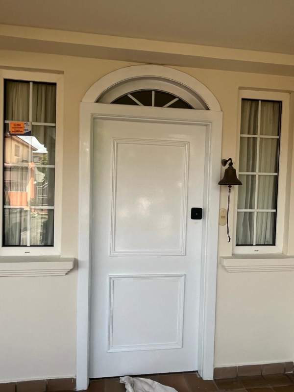 Indoor tiled staircase with decorative black iron railing duplex house Brisas del Golf Panama