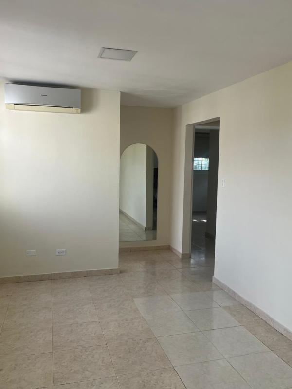 Covered parking area with terracotta tiles and white walls Residencial Riviera Colonial Brisas del Golf Panama