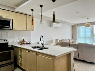 Modern kitchen with breakfast counter and barstools in beachfront condo PH Coronado Bay Nueva Gorgona Panama