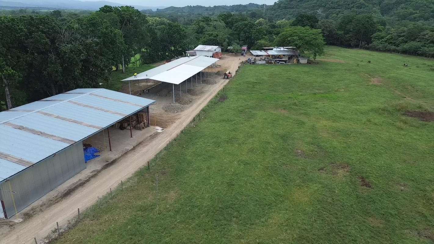 Aerial showing farm sheds, pasture land and mountain panorama Las Margaritas Chepo