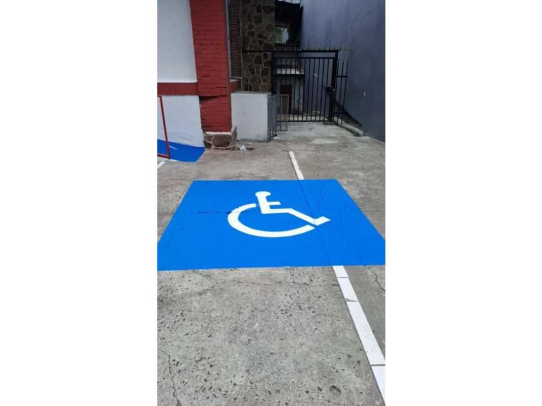 Exterior red tile roof, awnings over entrance, parking area of commercial property in Bella Vista Panama City