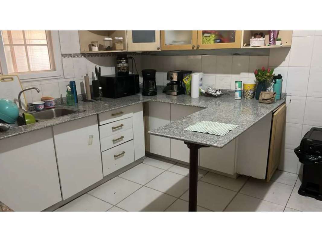 Kitchen with granite counters white cabinets appliances in Altos de la Castellana Panama City