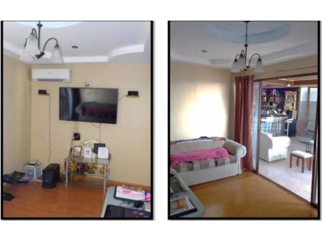 Living room with mounted TV glass sliding doors recessed lights in Panama house