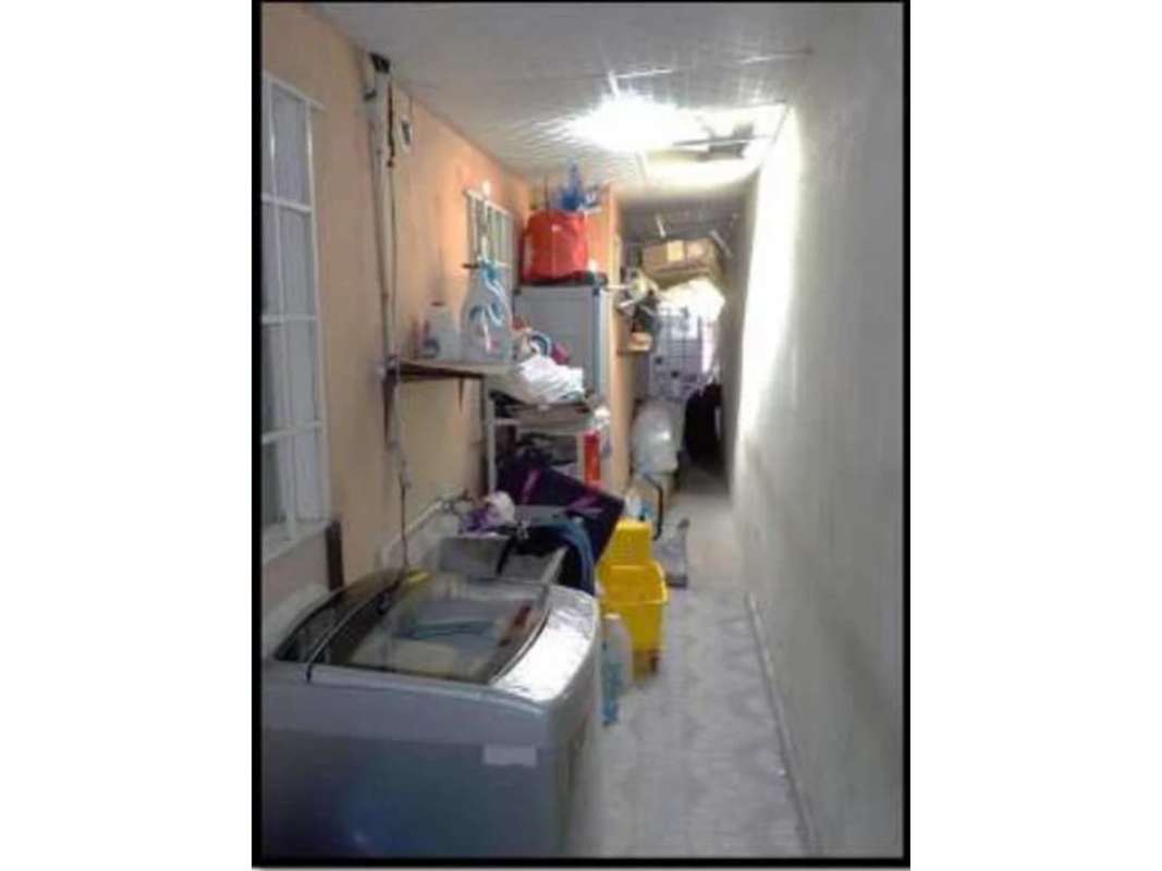 Laundry corridor with washing machine shelves exposed pipes Altos de la Castellana home