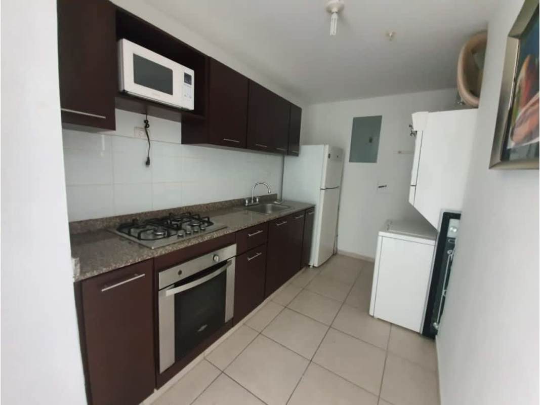 Modern kitchen with dark cabinets, granite countertops, built-in oven, gas stove, washing machine in PH Alsacia Tower Panama
