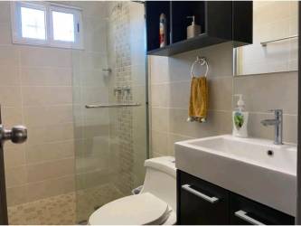 Modern bathroom with glass shower, tile accents and vanity in Villas del Maria Chame Panama