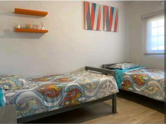 Bedroom with two twin beds and colorful decor Villas del Maria Chame Panama