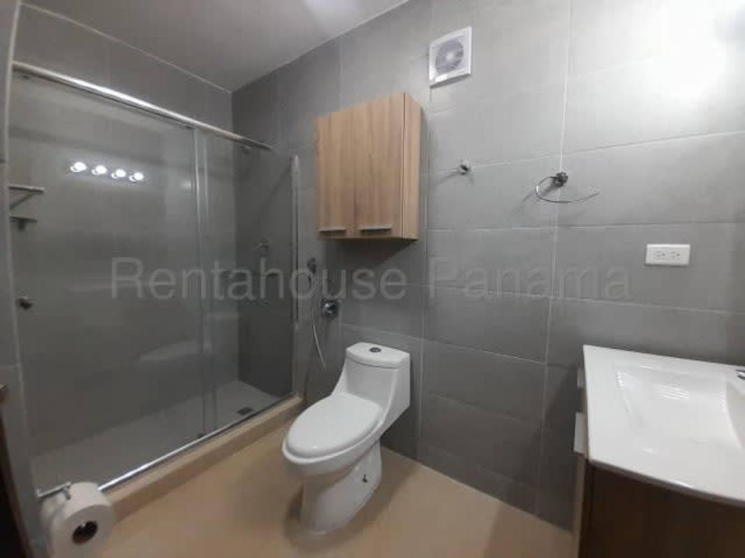 Spacious bedroom with built-in dark wood closet and ceiling fan in apartment at PH Oasis San Francisco