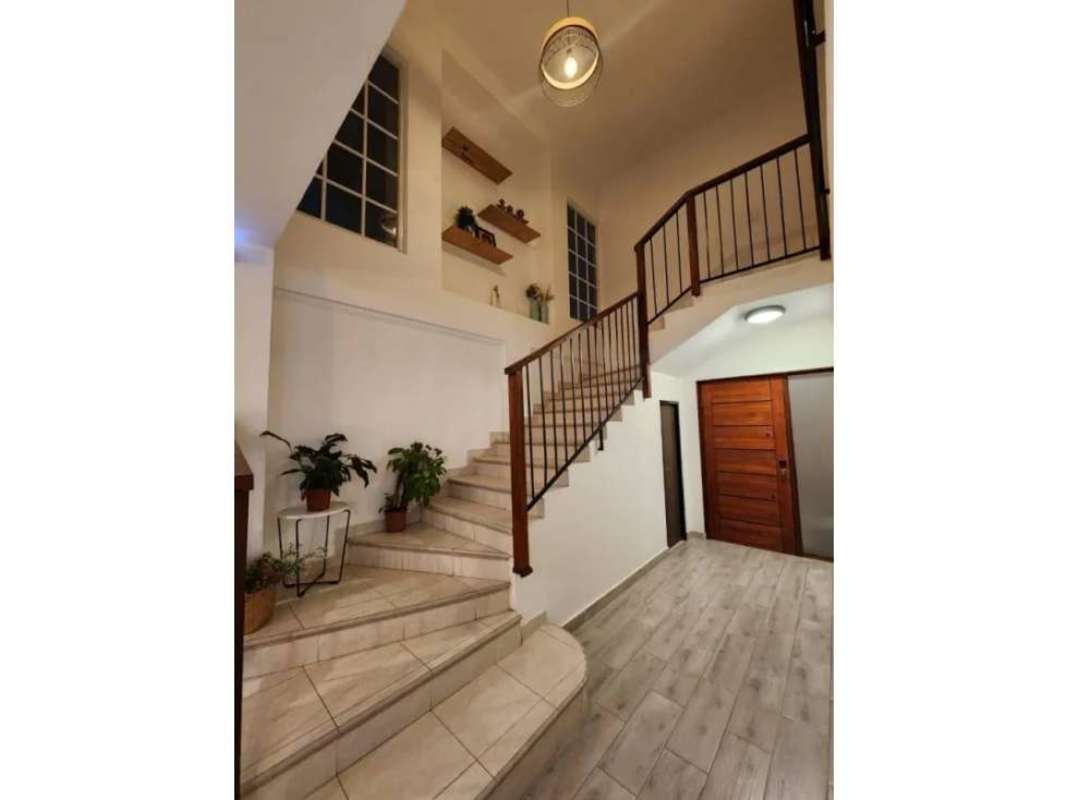 Spacious living room with tile floors and large windows in Villa Valencia Costa Sur Panama City