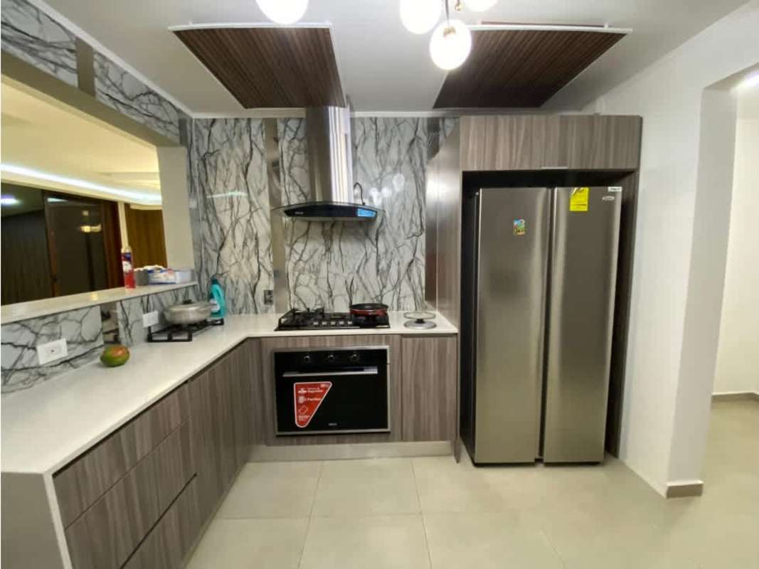 Modern kitchen with wood cabinets marble backsplash stainless appliances PH Gardenias Brisas del Golf