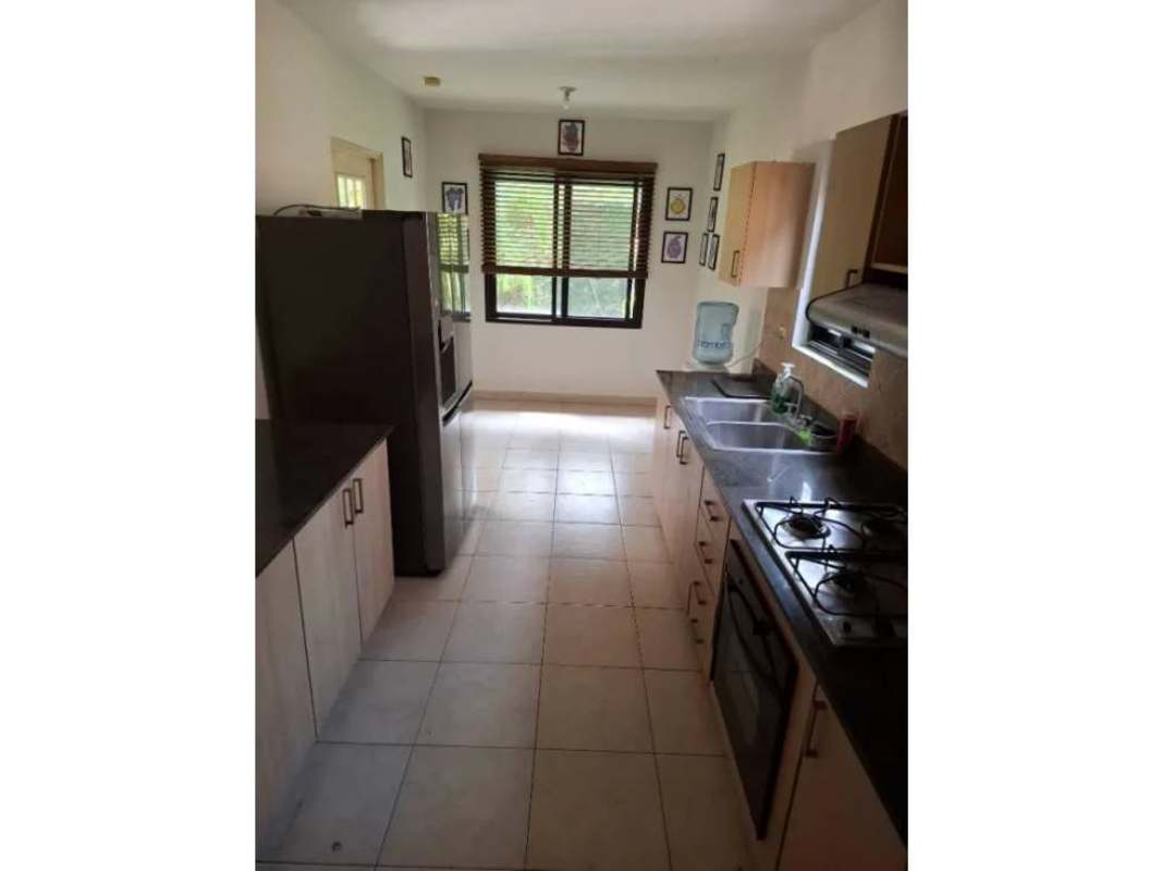 Kitchen with granite counters, fridge, cabinets in Versalles gated community Panama