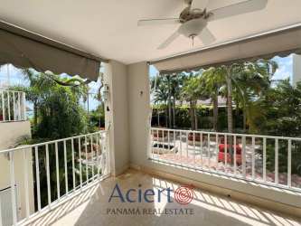 Covered balcony space with views over tropical gardens and pool Buenaventura Panama apartment