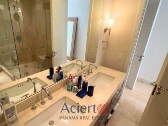 Chef kitchen with bar seating open to living area Buenaventura resort apartment Panama