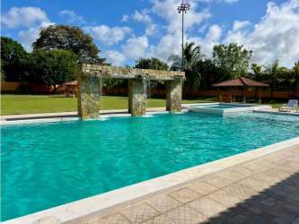 Large outdoor pool with lawn and lounge chairs in Chame Panama Villas Campestre del Sol