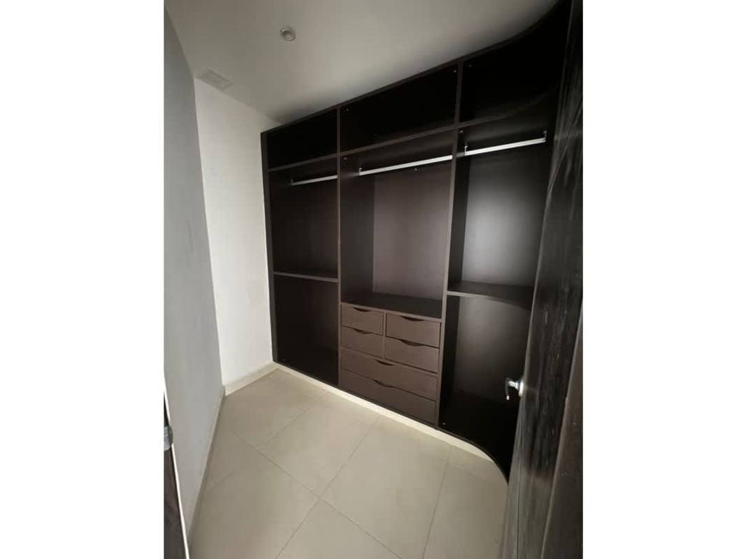 Walk-in closet with dark shelving and drawers in PH Embassy Village Panama