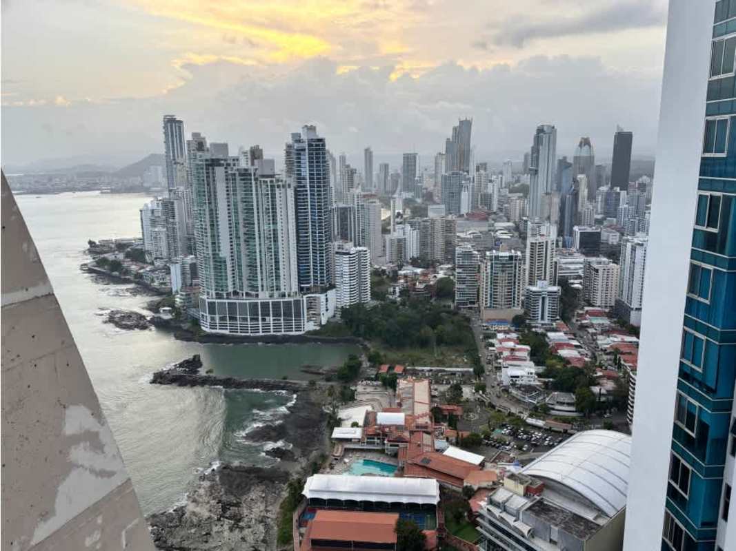 Modern open-plan living-dining area with ocean view balcony at PH Ocean Club Panama