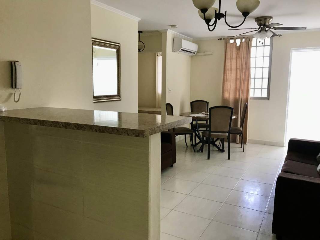 Compact galley kitchen with granite bar, appliances, laundry area in affordable Parque Lefevre apartment