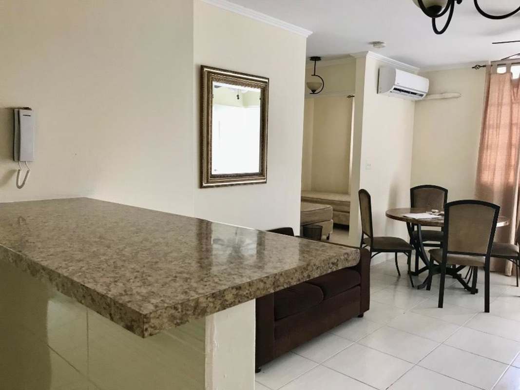 Bedroom with built-in closet, window, neutral colors in PH Parque Lefevre affordable apartment Panama City