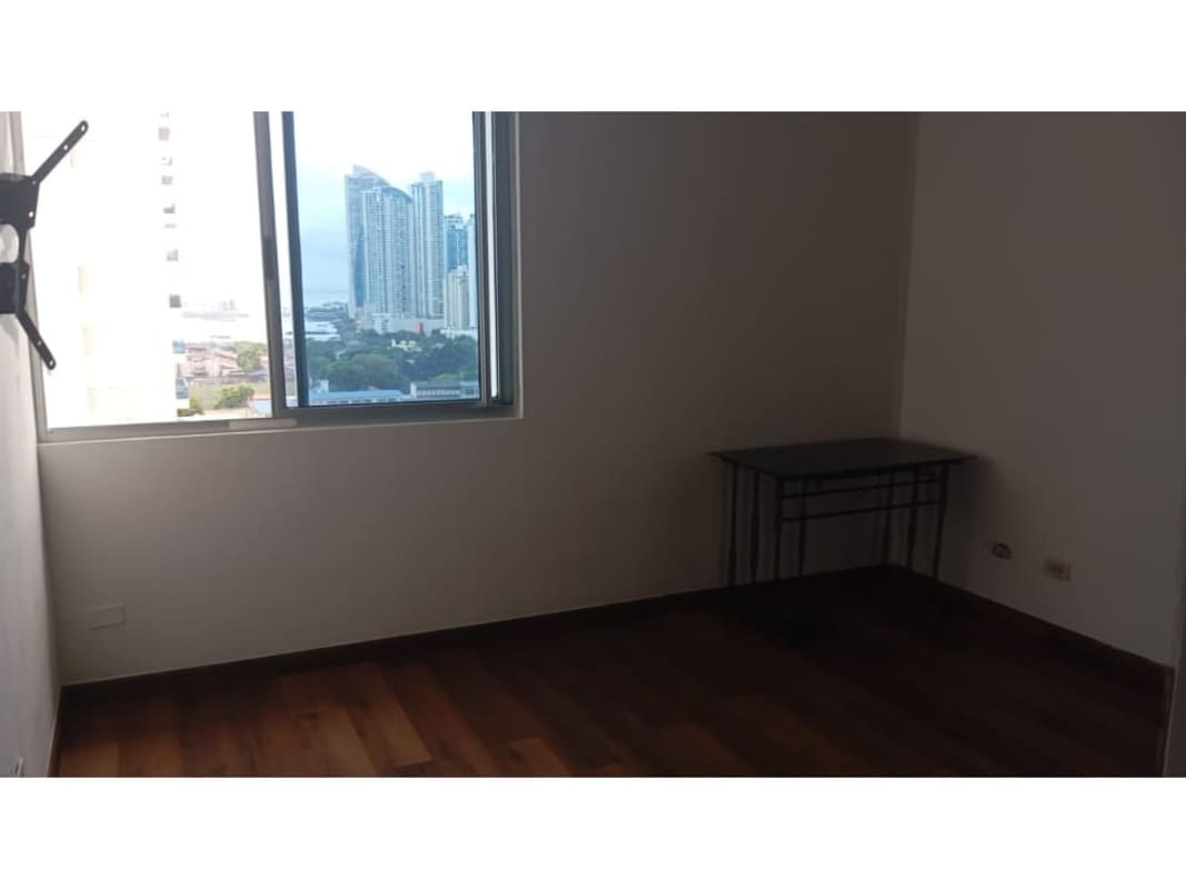 Bedroom with flat-screen TV, blue bedding, and wood floors in PH Infinity Tower Panama City