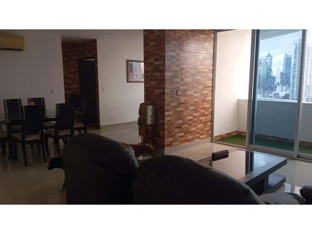 Open plan living and dining space with balcony access overlooking city skyline Panama
